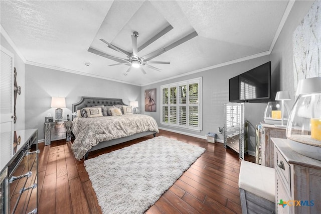 2203 Antelope Trl, Harker Heights, TX 76548 - bedroom with dark wood finished floors, ornamental molding, a ceiling fan, a raised ceiling, and a textured ceiling