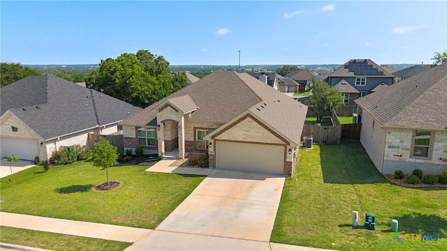 2416 Macdougal St, Nolanville, TX 76559 - view of front of property featuring driveway, stone siding, an attached garage, central air condition unit, and a residential view