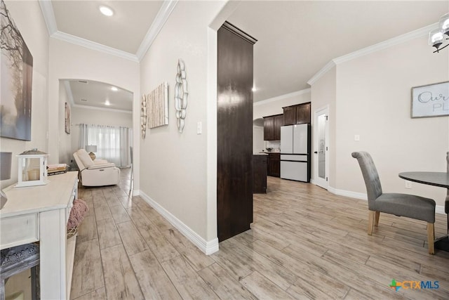 2416 Macdougal St, Nolanville, TX 76559 - hall with light wood-type flooring, arched walkways, baseboards, ornamental molding, and recessed lighting