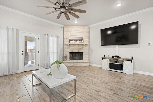 2416 Macdougal St, Nolanville, TX 76559 - living room featuring ornamental molding, ceiling fan, baseboards, a stone fireplace, and wood finished floors