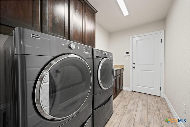 2416 Macdougal St, Nolanville, TX 76559 - laundry area with washer and dryer, cabinet space, baseboards, and light wood-type flooring
