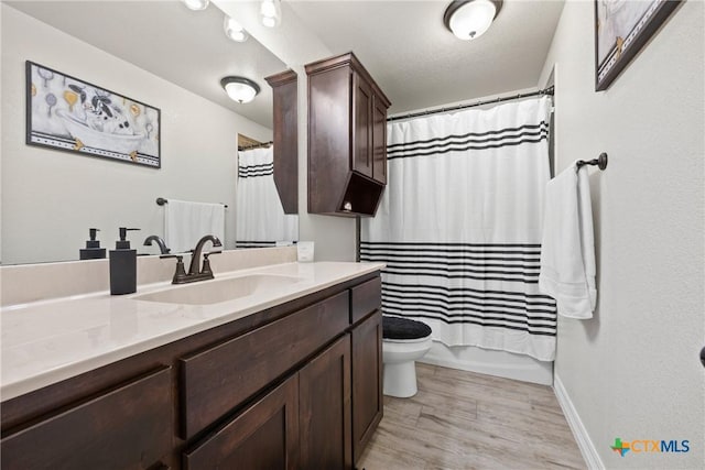 2416 Macdougal St, Nolanville, TX 76559 - bathroom featuring vanity, toilet, wood finished floors, and baseboards
