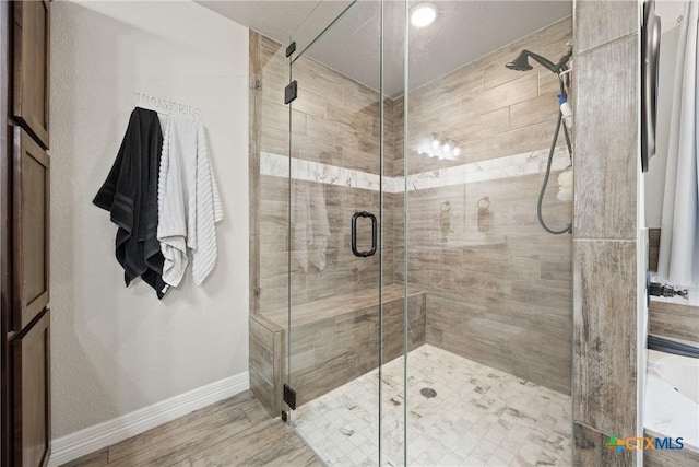 2416 Macdougal St, Nolanville, TX 76559 - bathroom featuring baseboards, a shower stall, and wood finished floors