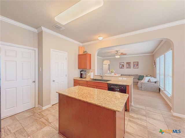 2321 Vicksburg Ln, Temple, TX 76504 - kitchen featuring arched walkways, crown molding, a peninsula, a center island, and open floor plan
