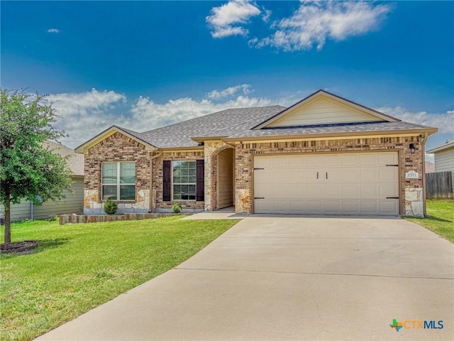 2321 Vicksburg Ln, Temple, TX 76504 - ranch-style house with brick siding, a garage, driveway, and a front yard