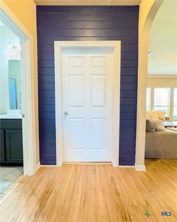 2321 Vicksburg Ln, Temple, TX 76504 - interior space with arched walkways, light wood-type flooring, and wood walls