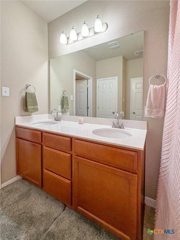 2321 Vicksburg Ln, Temple, TX 76504 - full bathroom with double vanity and baseboards