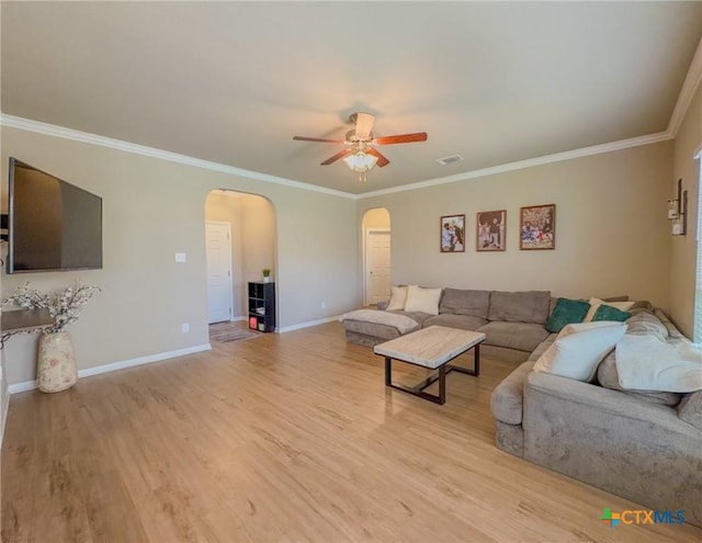 2321 Vicksburg Ln, Temple, TX 76504 - living room with arched walkways, a ceiling fan, light wood-type flooring, and crown molding