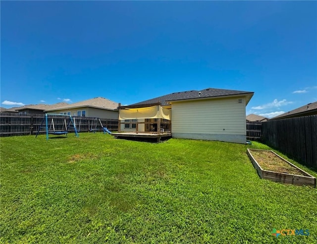 2321 Vicksburg Ln, Temple, TX 76504 - back of property featuring a playground, a fenced backyard, a vegetable garden, and a deck