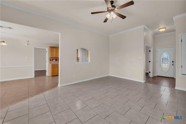 interior space featuring visible vents, ornamental molding, light tile patterned flooring, baseboards, and ceiling fan