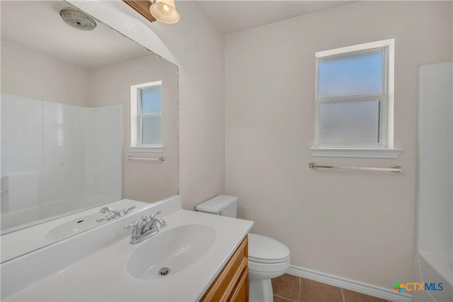 bathroom featuring tile patterned flooring, toilet, vanity, and baseboards