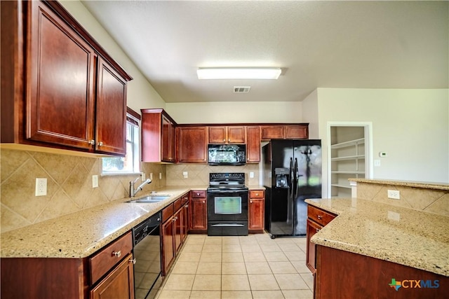 5414 Birmingham Cir, Killeen, TX 76542 - kitchen with black appliances, a sink, reddish brown cabinets, tasteful backsplash, and light stone counters