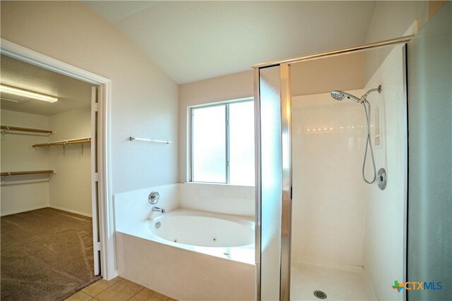 5414 Birmingham Cir, Killeen, TX 76542 - full bathroom with a stall shower, a jetted tub, lofted ceiling, a walk in closet, and tile patterned floors