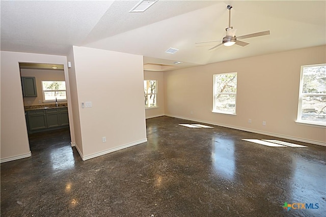 empty room featuring baseboards, visible vents, and a healthy amount of sunlight