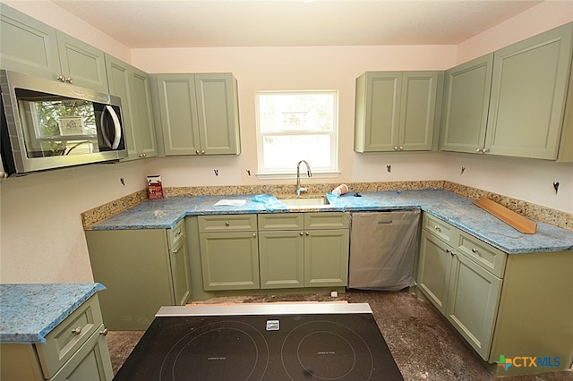 kitchen with sink, green cabinetry, and stainless steel appliances