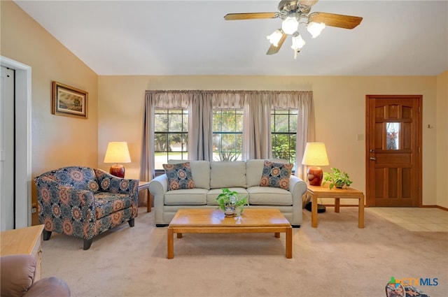 carpeted living room featuring ceiling fan, lofted ceiling, and a healthy amount of sunlight