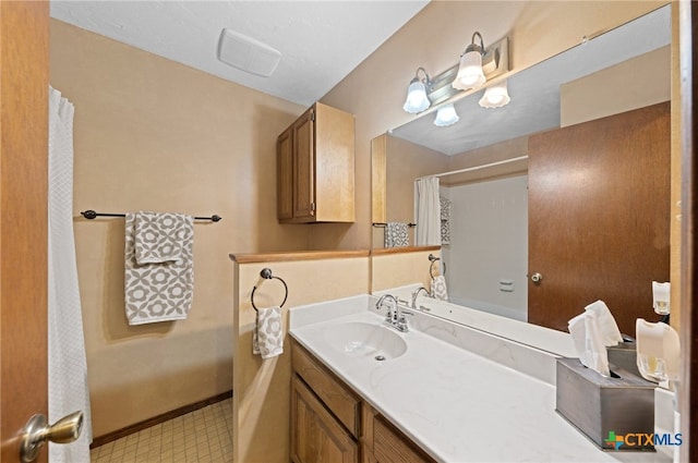 bathroom featuring vanity and a shower with shower curtain