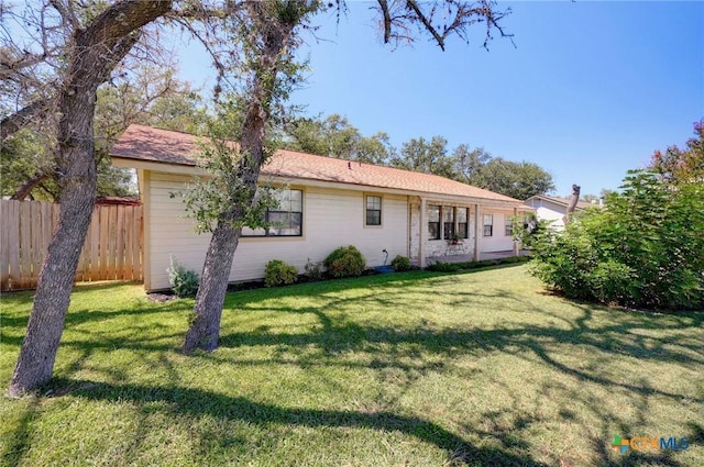 rear view of property featuring a lawn