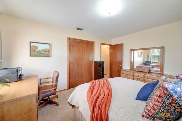 bedroom featuring light carpet and a closet