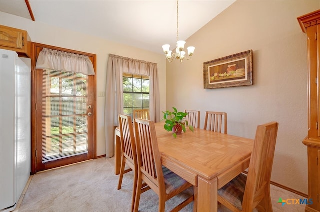 carpeted dining room featuring an inviting chandelier and lofted ceiling