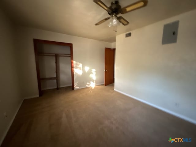 unfurnished bedroom with carpet, ceiling fan, and a closet