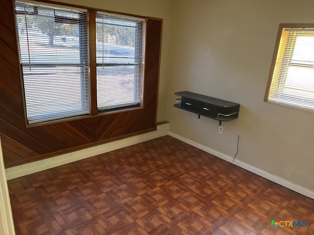 spare room with dark parquet floors