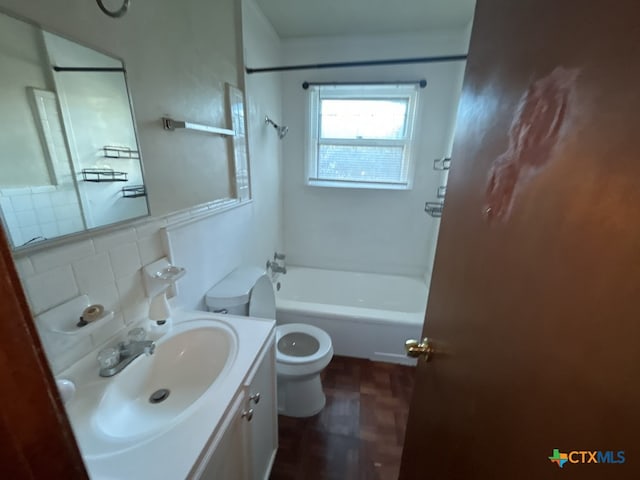 full bathroom with hardwood / wood-style floors, toilet, decorative backsplash, shower / washtub combination, and vanity