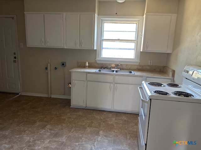 kitchen with white range with electric cooktop, white cabinetry, and sink