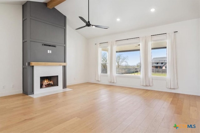 unfurnished living room with baseboards, beamed ceiling, light wood-type flooring, a fireplace, and a ceiling fan