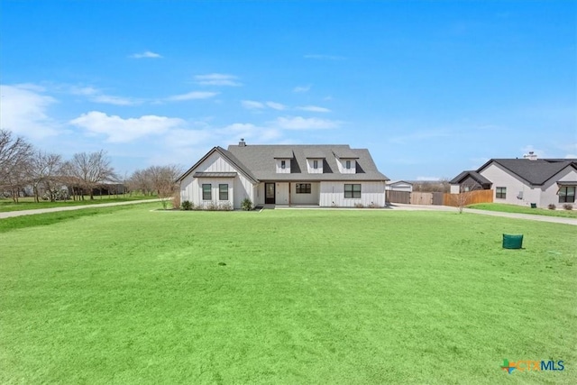 view of front of property with a front yard and fence