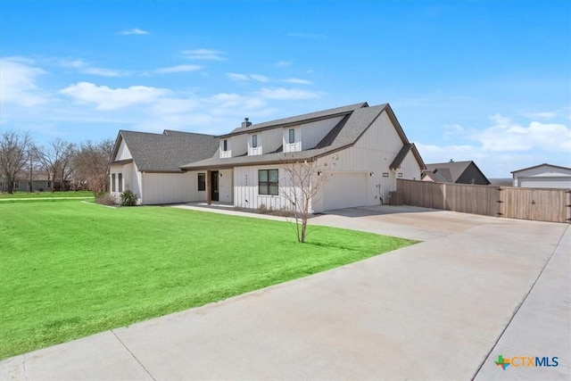 modern inspired farmhouse featuring an attached garage, fence, a front yard, driveway, and a gate