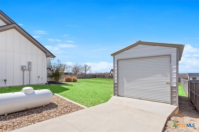 detached garage with fence and driveway