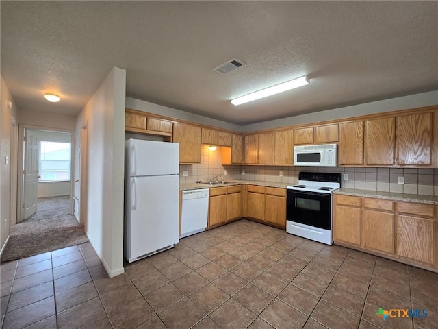 4101 Shasta, Copperas Cove, TX 76522 - kitchen featuring white appliances, a textured ceiling, light countertops, dark tile patterned flooring, and a sink