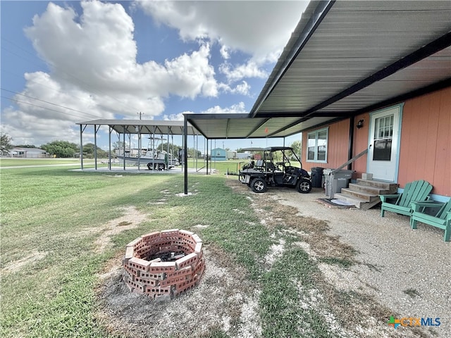 exterior space featuring a lawn and a fire pit