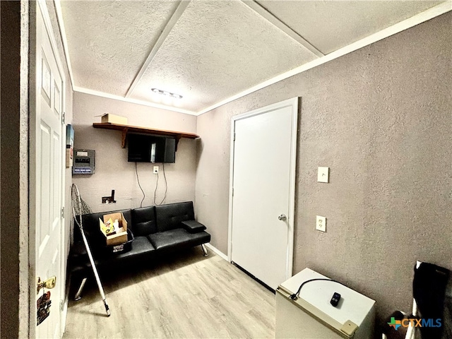 interior space featuring wood-type flooring and crown molding