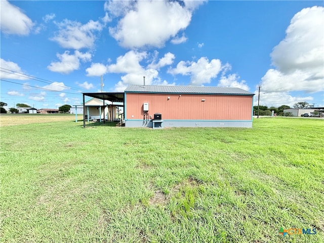 rear view of property with a yard