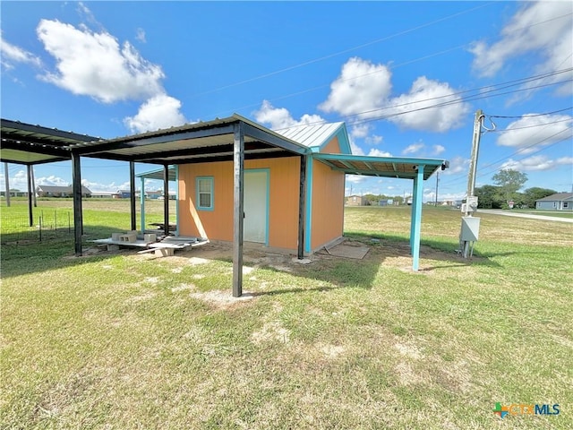 101 N 13th St, Seadrift, TX 77983 - back of property featuring a lawn and an outbuilding
