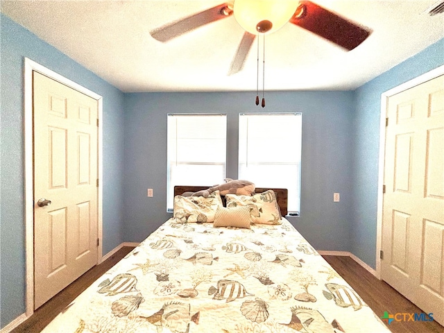 bedroom featuring ceiling fan and dark hardwood / wood-style floors