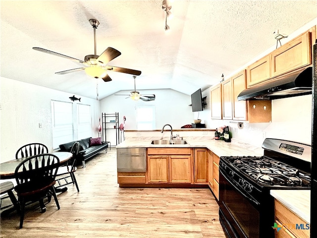 kitchen featuring a textured ceiling, black range with gas stovetop, sink, vaulted ceiling, and light hardwood / wood-style floors