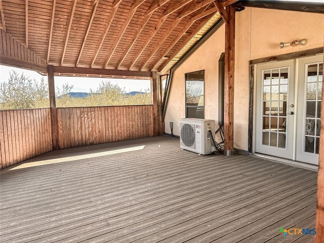 deck featuring ac unit and french doors