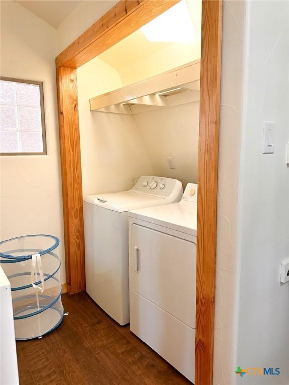 washroom featuring dark hardwood / wood-style flooring and washer and dryer