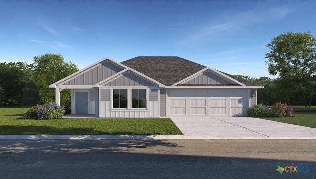 view of front facade with a front yard and a garage