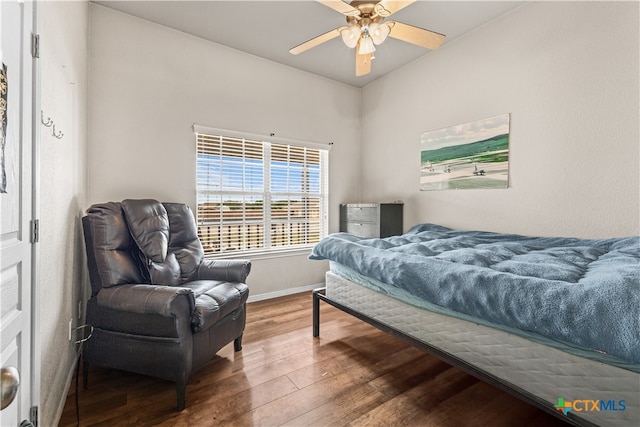 bedroom with ceiling fan, baseboards, and wood finished floors