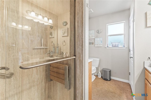 full bathroom featuring toilet, vanity, baseboards, a shower stall, and tile patterned floors