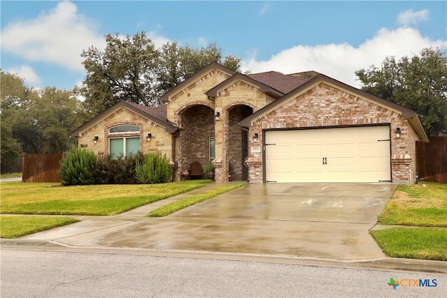 view of front of house with a front yard and a garage