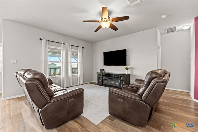 31682 Nimbus Dr, Bulverde, TX 78163 - living room featuring ceiling fan, light wood-style flooring, and baseboards