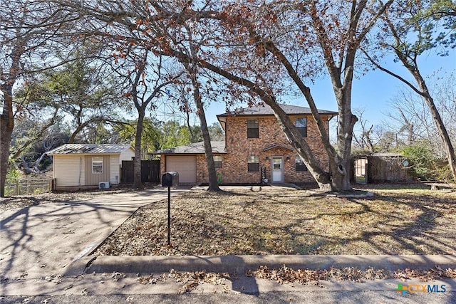 rear view of house featuring a shed and a garage