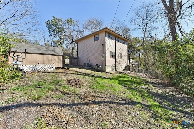 exterior space with cooling unit and a shed