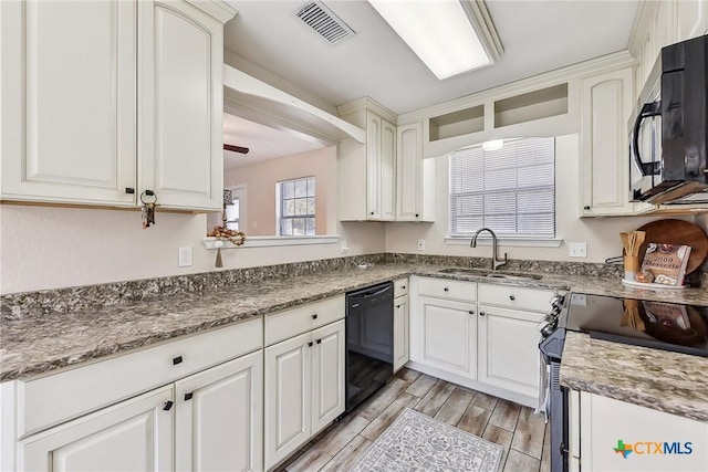 kitchen with sink, white cabinetry, black dishwasher, light stone counters, and stainless steel electric stove