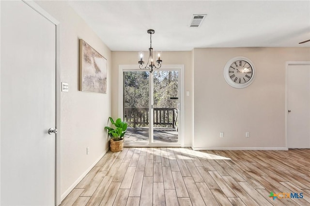 unfurnished dining area with an inviting chandelier